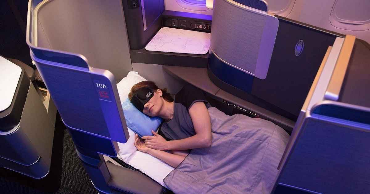 Women sleeping on United Airlines Polaris lie flat seat